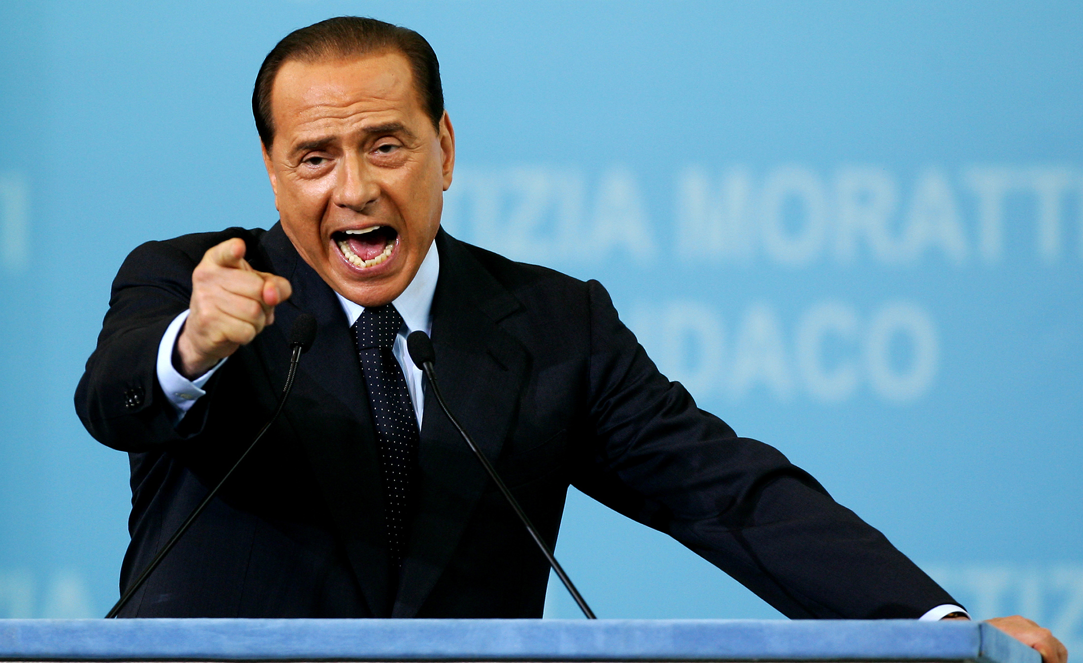 Italian outgoing PM Silvio Berlusconi gestures while opening Letizia Moratti's electoral campign in Milan